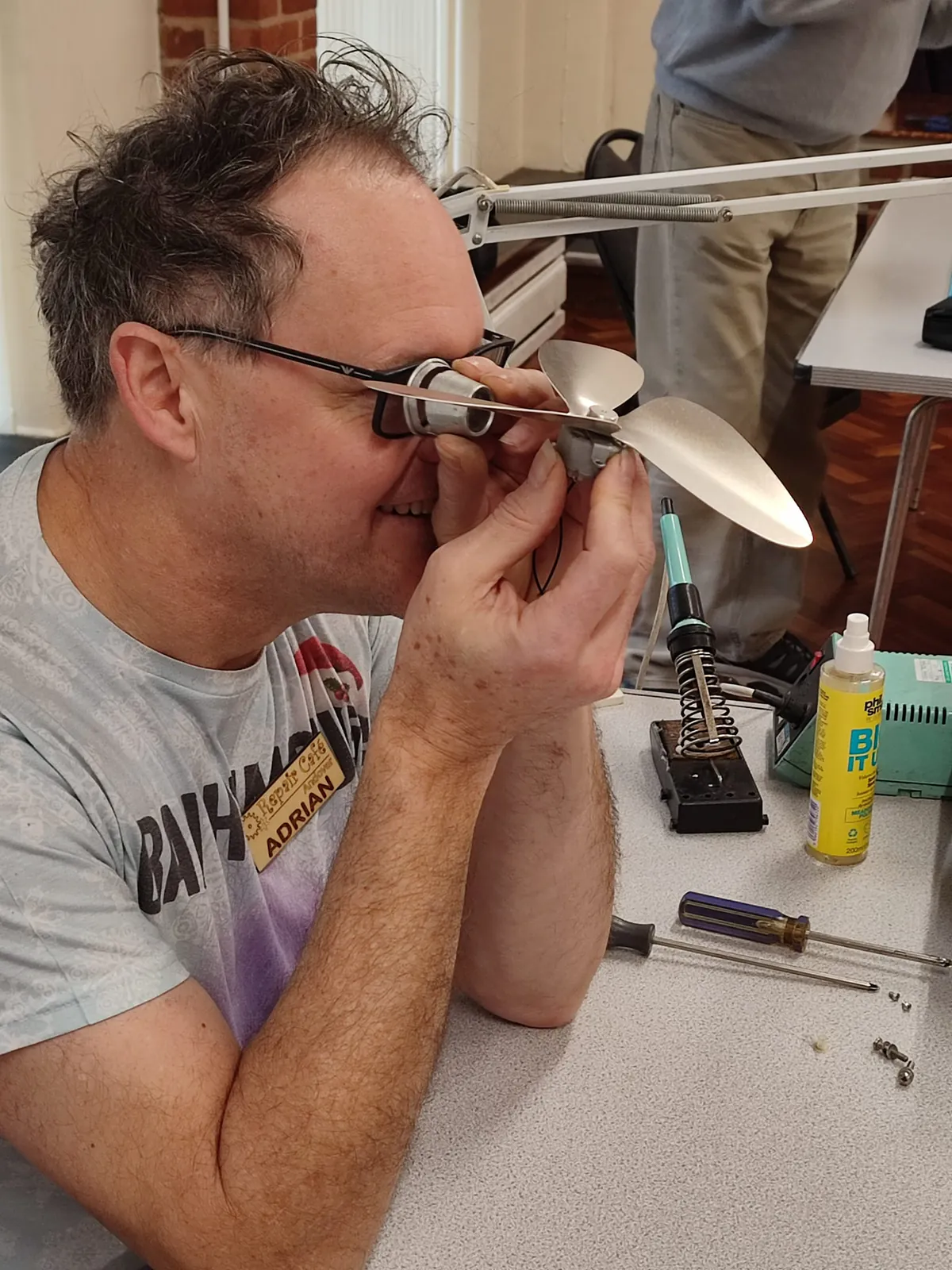 Repair Café volunteers explaining repair process